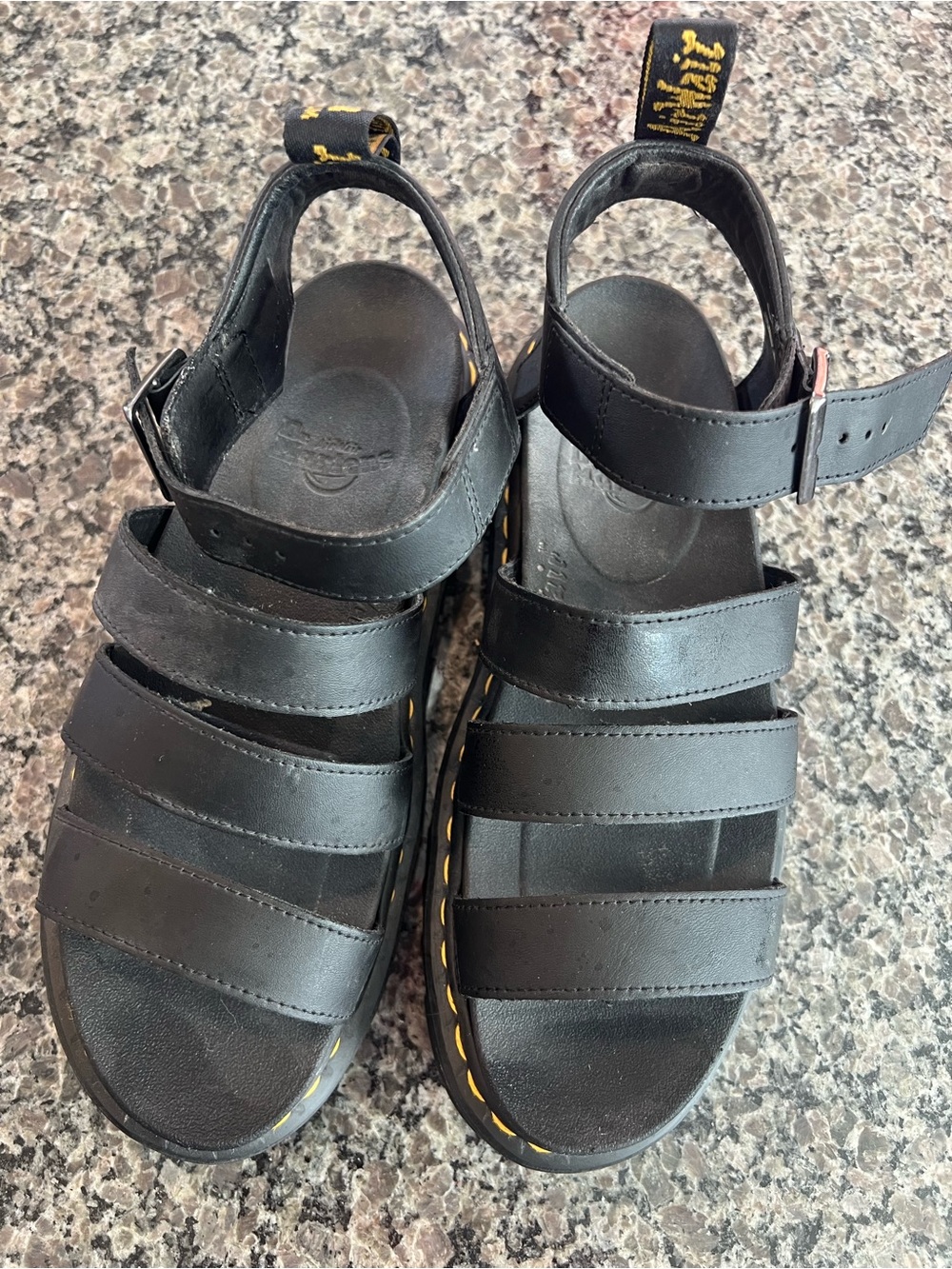 Dr. Martens Black Leather Strappy Lug-Sole Sandals with Yellow Stitching